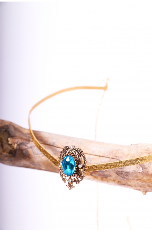 Golden crown or tiara with blue crystal